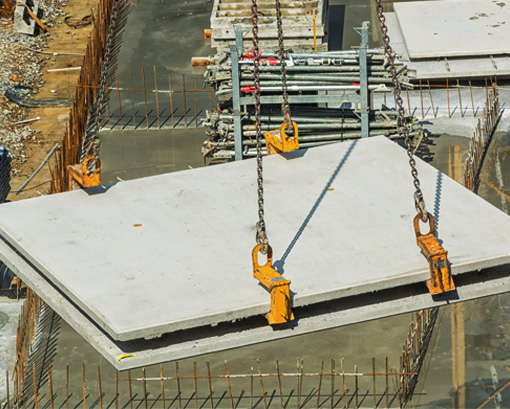 Concrete panels being moved into place by crane